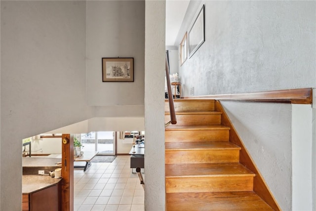331 Lake View Dr NE, Solon, IA 52333 - stairs with tile patterned flooring and a high ceiling