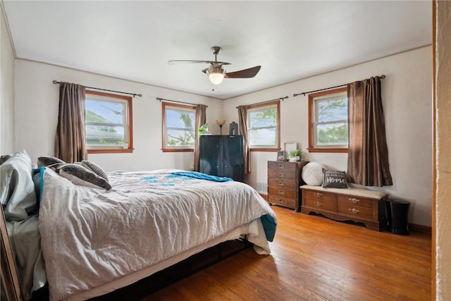 331 Lake View Dr NE, Solon, IA 52333 - bedroom featuring multiple windows, light wood finished floors, and a ceiling fan