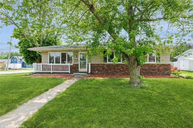 3099 27th Ave, Marion, IA 52302 - view of front of house with brick siding, a front lawn, and a porch