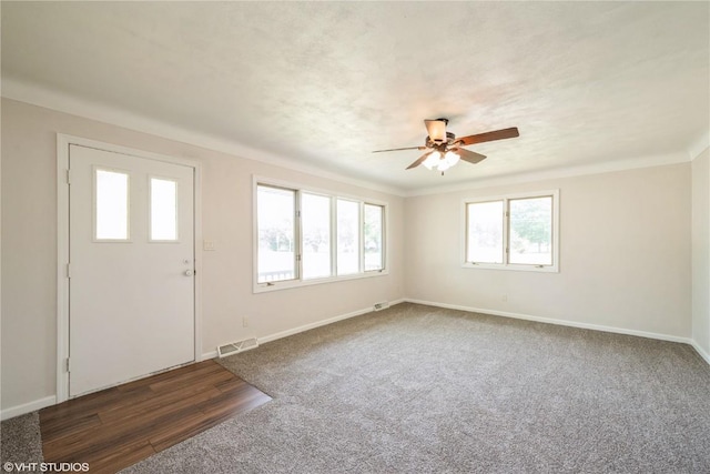 3099 27th Ave, Marion, IA 52302 - entrance foyer featuring ceiling fan, baseboards, and dark colored carpet