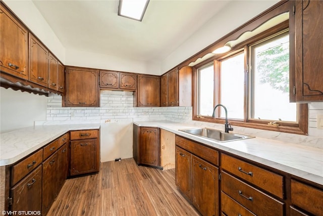3099 27th Ave, Marion, IA 52302 - kitchen with a sink, wood finished floors, backsplash, and light countertops