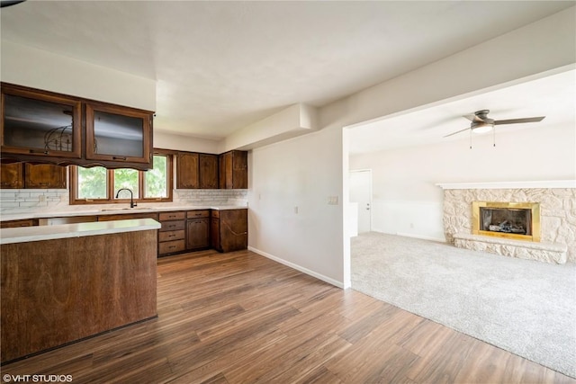 3099 27th Ave, Marion, IA 52302 - kitchen with a sink, light countertops, dark wood-type flooring, ceiling fan, and decorative backsplash