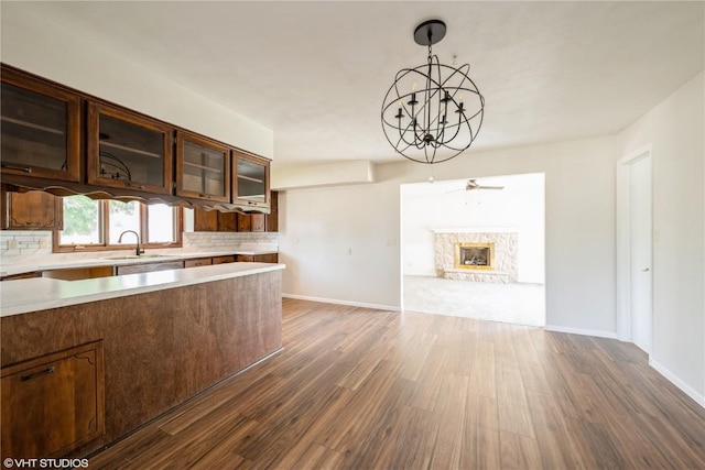 3099 27th Ave, Marion, IA 52302 - kitchen with dark wood-type flooring, a sink, light countertops, and decorative backsplash