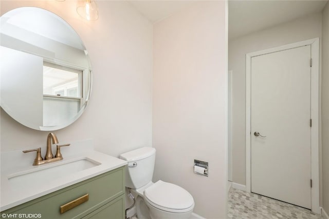 3099 27th Ave, Marion, IA 52302 - bathroom featuring vanity, toilet, and baseboards