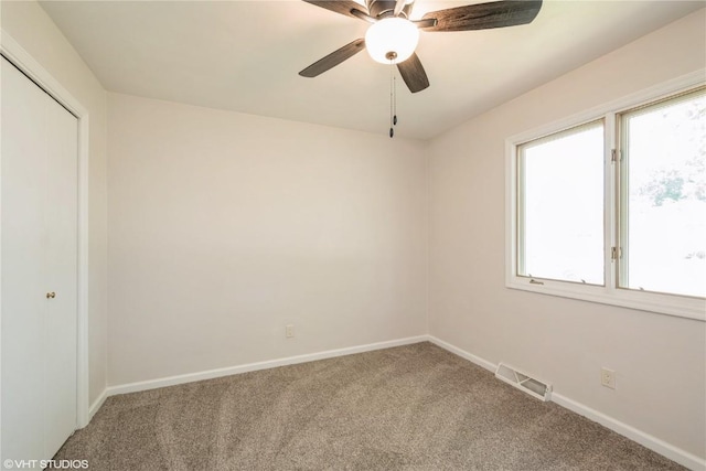 3099 27th Ave, Marion, IA 52302 - spare room featuring carpet floors, healthy amount of natural light, baseboards, and ceiling fan