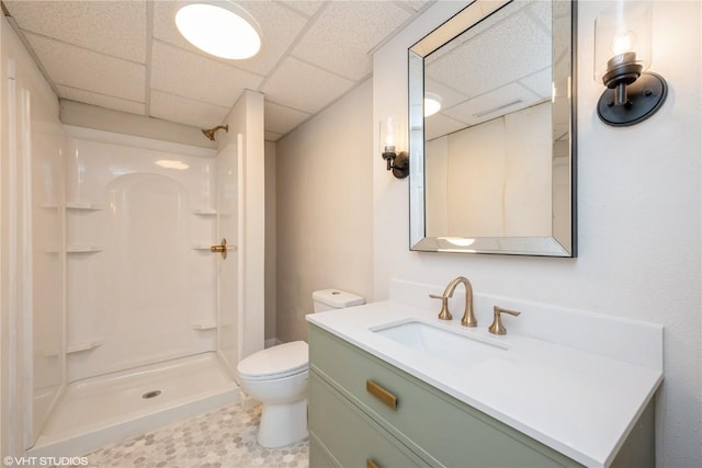 3099 27th Ave, Marion, IA 52302 - full bathroom featuring a paneled ceiling, a shower, vanity, and toilet