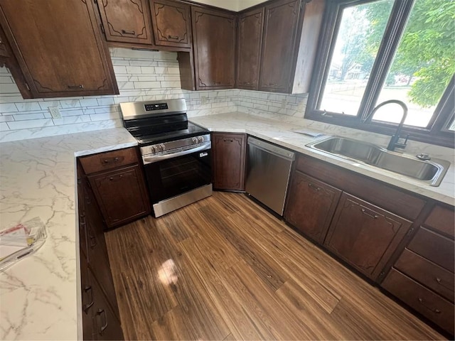 3099 27th Ave, Marion, IA 52302 - kitchen featuring appliances with stainless steel finishes, dark wood-type flooring, decorative backsplash, and dark brown cabinetry