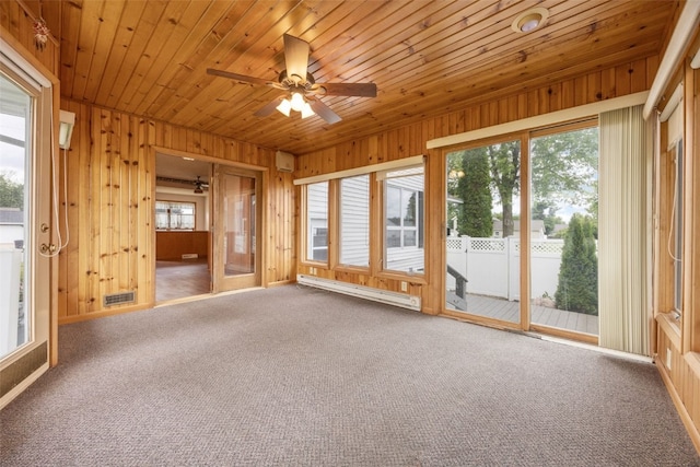 502 5th Ave, Clarence, IA 52216 - unfurnished sunroom featuring baseboard heating, a ceiling fan, carpet, wood walls, and wooden ceiling