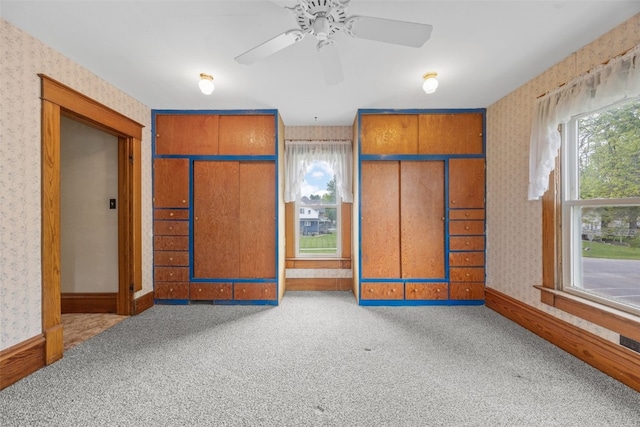 502 5th Ave, Clarence, IA 52216 - carpeted spare room featuring wallpapered walls, ceiling fan, and baseboards
