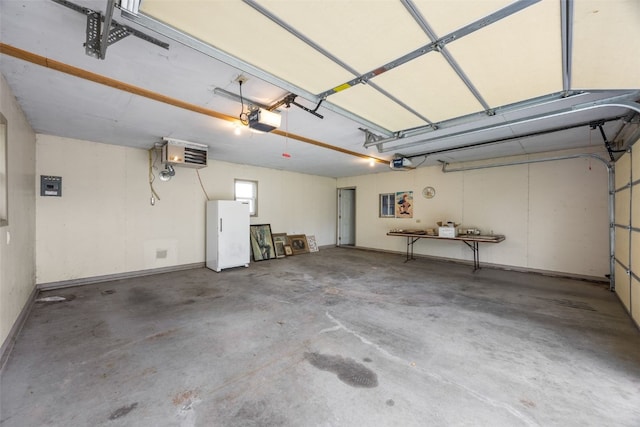 502 5th Ave, Clarence, IA 52216 - garage featuring a garage door opener, freestanding refrigerator, and a heating unit