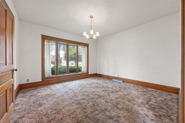502 5th Ave, Clarence, IA 52216 - carpeted spare room featuring a chandelier and baseboards
