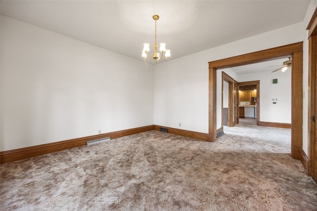 502 5th Ave, Clarence, IA 52216 - carpeted empty room featuring a chandelier, baseboards, and a ceiling fan
