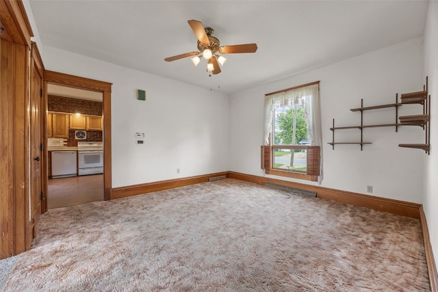 502 5th Ave, Clarence, IA 52216 - empty room featuring carpet, a ceiling fan, and baseboards