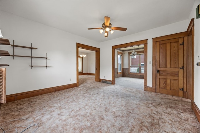 502 5th Ave, Clarence, IA 52216 - carpeted empty room with a ceiling fan, a chandelier, and baseboards