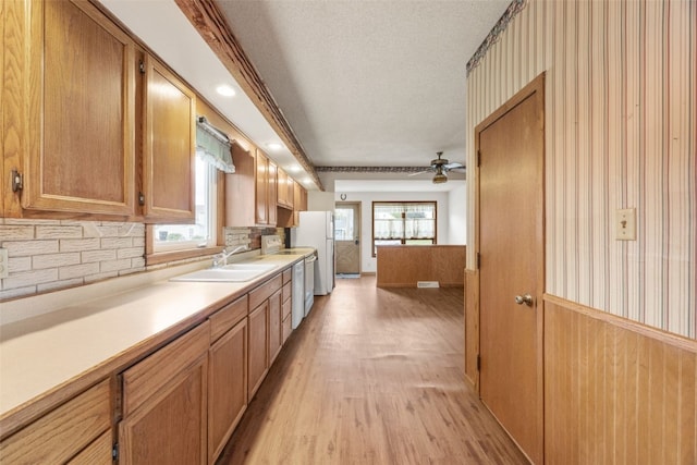 502 5th Ave, Clarence, IA 52216 - kitchen with a sink, freestanding refrigerator, light wood-type flooring, light countertops, and a textured ceiling