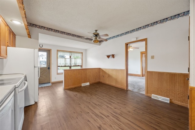 502 5th Ave, Clarence, IA 52216 - kitchen with ceiling fan, a wainscoted wall, a textured ceiling, white range with electric cooktop, and wood finished floors