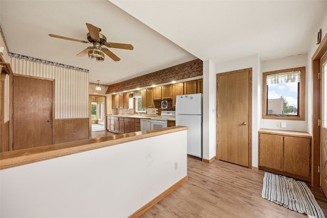 502 5th Ave, Clarence, IA 52216 - kitchen featuring white appliances, brown cabinets, ceiling fan, light wood-style flooring, and light countertops