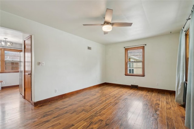 722 47th Ave, Amana, IA 52203 - empty room with hardwood / wood-style floors, ceiling fan, and baseboards