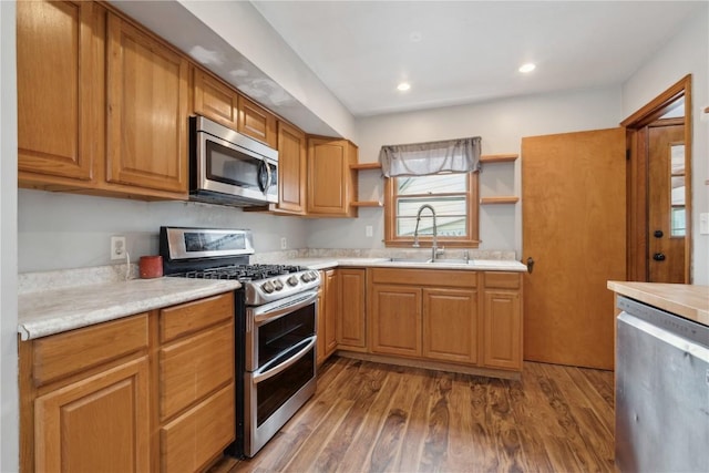 722 47th Ave, Amana, IA 52203 - kitchen featuring stainless steel appliances, a sink, open shelves, light countertops, and dark wood-style floors