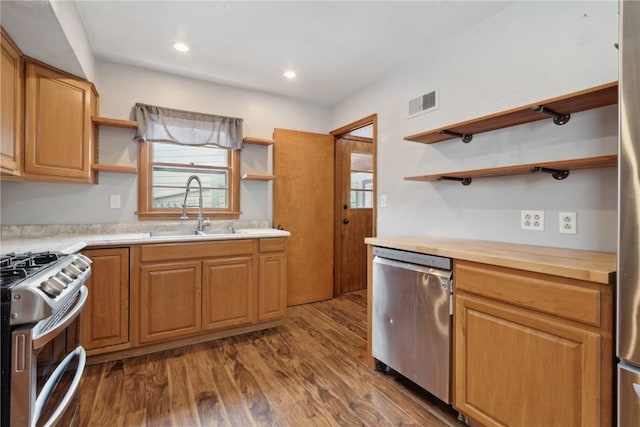 722 47th Ave, Amana, IA 52203 - kitchen with open shelves, stainless steel appliances, a sink, wood finished floors, and recessed lighting