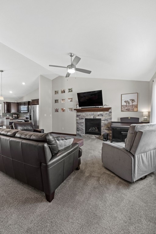 2106 Shady Grove Rd SW, Cedar Rapids, IA 52404 - carpeted living area featuring lofted ceiling, a ceiling fan, a fireplace, and recessed lighting
