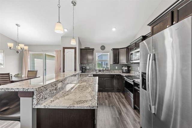 2106 Shady Grove Rd SW, Cedar Rapids, IA 52404 - kitchen featuring appliances with stainless steel finishes, plenty of natural light, dark brown cabinets, and backsplash