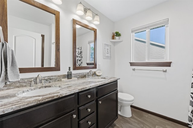 2106 Shady Grove Rd SW, Cedar Rapids, IA 52404 - full bath featuring double vanity, wood finished floors, toilet, and baseboards