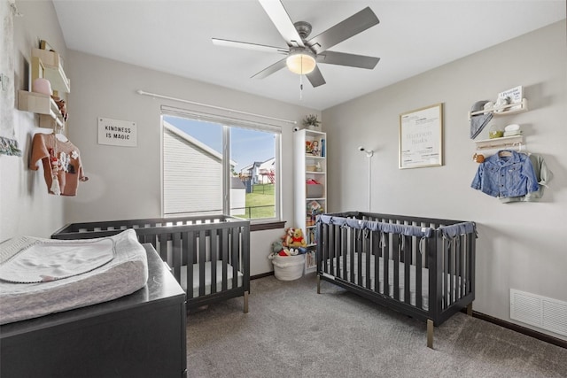 2106 Shady Grove Rd SW, Cedar Rapids, IA 52404 - bedroom featuring carpet, a crib, a ceiling fan, and baseboards