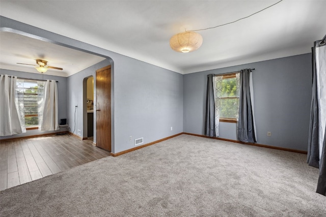 331 36th St NE, Cedar Rapids, IA 52402 - unfurnished room featuring healthy amount of natural light, baseboards, carpet, and arched walkways