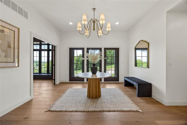 679 Allison Way, Iowa City, IA 52245 - unfurnished dining area with plenty of natural light, a chandelier, hardwood / wood-style floors, and recessed lighting