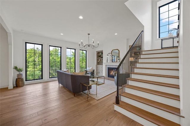 679 Allison Way, Iowa City, IA 52245 - living area with plenty of natural light, stairway, recessed lighting, light wood-type flooring, and a chandelier