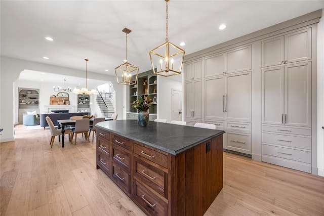 679 Allison Way, Iowa City, IA 52245 - kitchen featuring a chandelier, recessed lighting, light wood-style flooring, a kitchen island, and hanging light fixtures