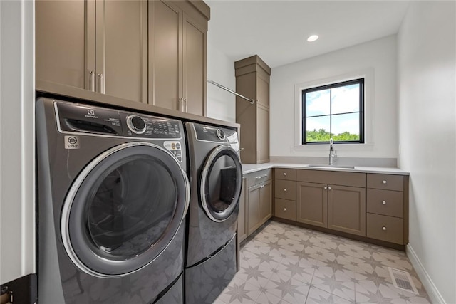 679 Allison Way, Iowa City, IA 52245 - washroom with separate washer and dryer, light floors, and cabinet space