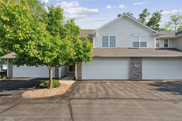 5794 Oakwood Ave NE Unit 2, Cedar Rapids, IA 52402 - view of front of property with brick siding, asphalt driveway, and roof with shingles