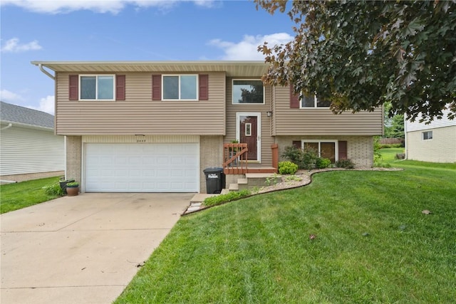 2445 Hillview Dr, Marion, IA 52302 - bi-level home featuring brick siding, a garage, a front yard, and concrete driveway