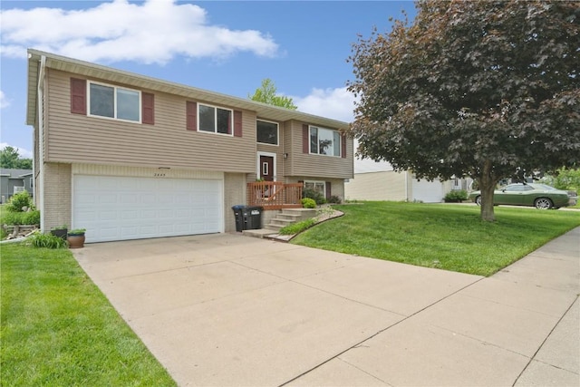 2445 Hillview Dr, Marion, IA 52302 - split foyer home with a garage, brick siding, a front yard, and concrete driveway