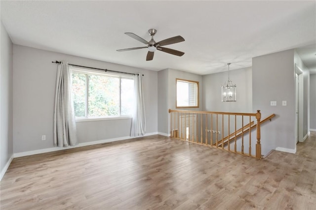 2445 Hillview Dr, Marion, IA 52302 - spare room with wood finished floors, a chandelier, baseboards, and ceiling fan
