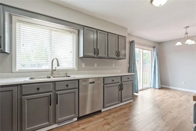 2445 Hillview Dr, Marion, IA 52302 - kitchen featuring stainless steel dishwasher, gray cabinets, a sink, a chandelier, and light countertops