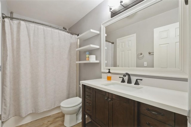 2445 Hillview Dr, Marion, IA 52302 - full bathroom with vanity, toilet, and wood finished floors