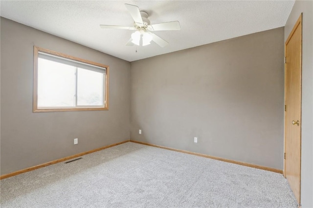 2445 Hillview Dr, Marion, IA 52302 - carpeted spare room with a ceiling fan, baseboards, and a textured ceiling