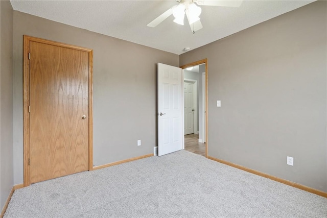2445 Hillview Dr, Marion, IA 52302 - unfurnished bedroom with carpet flooring, baseboards, a ceiling fan, and a closet