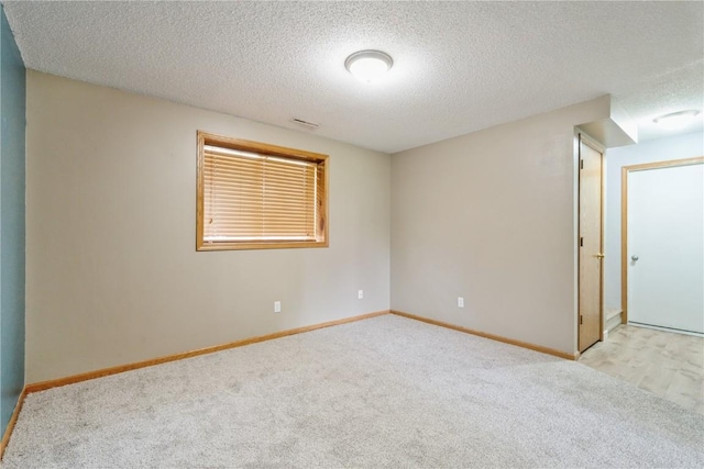 2445 Hillview Dr, Marion, IA 52302 - empty room with carpet, a textured ceiling, and baseboards
