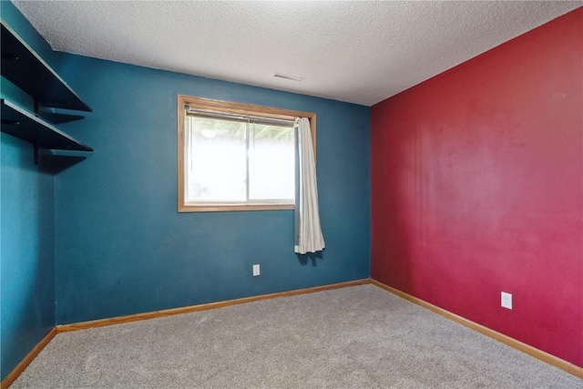 2445 Hillview Dr, Marion, IA 52302 - carpeted spare room featuring a textured ceiling and baseboards