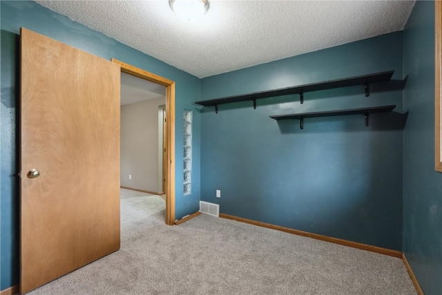 2445 Hillview Dr, Marion, IA 52302 - empty room with carpet flooring, a textured ceiling, and baseboards
