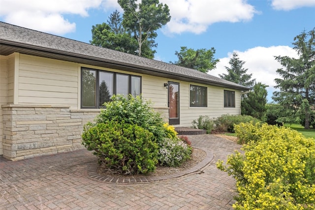 4519 Indian Creek Rd, Marion, IA 52302 - ranch-style home featuring stone siding and a shingled roof