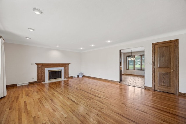 4519 Indian Creek Rd, Marion, IA 52302 - unfurnished living room with light wood-style floors, baseboards, a chandelier, recessed lighting, and a fireplace with flush hearth