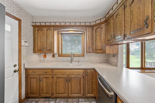 4519 Indian Creek Rd, Marion, IA 52302 - kitchen with a sink, stainless steel dishwasher, brown cabinets, light countertops, and wallpapered walls