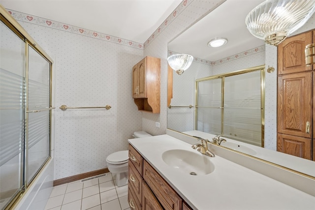 4519 Indian Creek Rd, Marion, IA 52302 - full bath with tile patterned flooring, toilet, vanity, wallpapered walls, and bath / shower combo with glass door