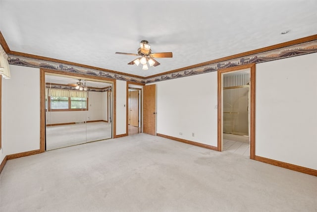 4519 Indian Creek Rd, Marion, IA 52302 - unfurnished bedroom with baseboards, crown molding, light carpet, and a ceiling fan