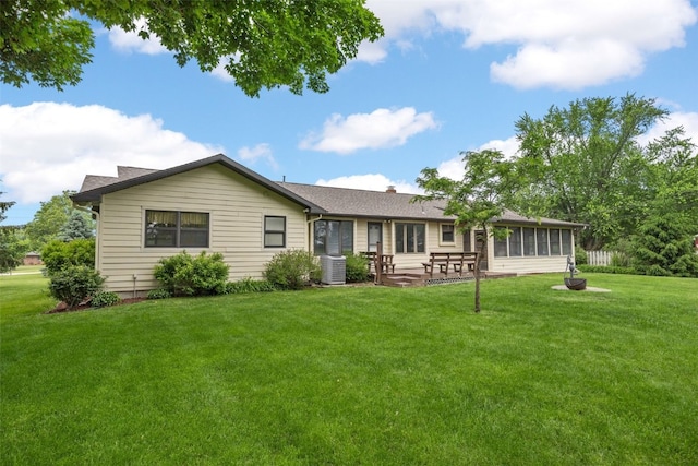 4519 Indian Creek Rd, Marion, IA 52302 - rear view of property with a sunroom, a yard, a patio area, central AC, and a chimney